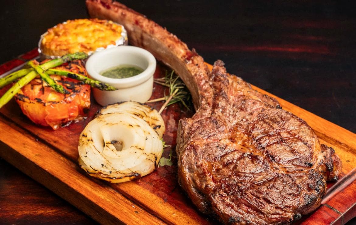 Premium Black Angus tomahawk steak served at Hartley Ranch Jaco Beach